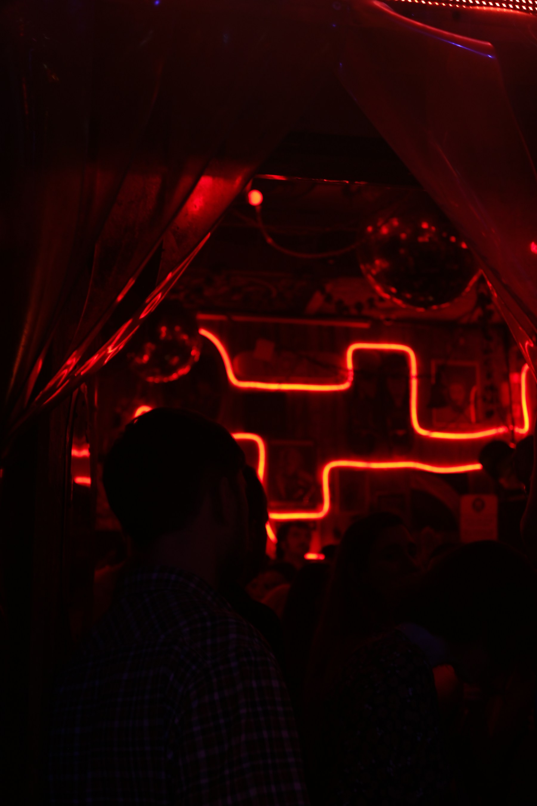 A club interior lit by red neon